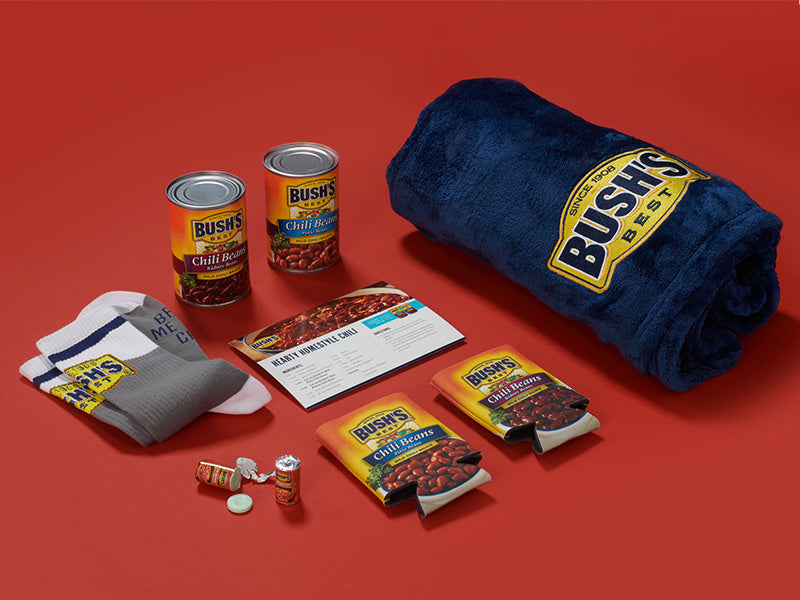 Netflix Chili Flat Lay with a navy blanket, mints, socks, and koozies